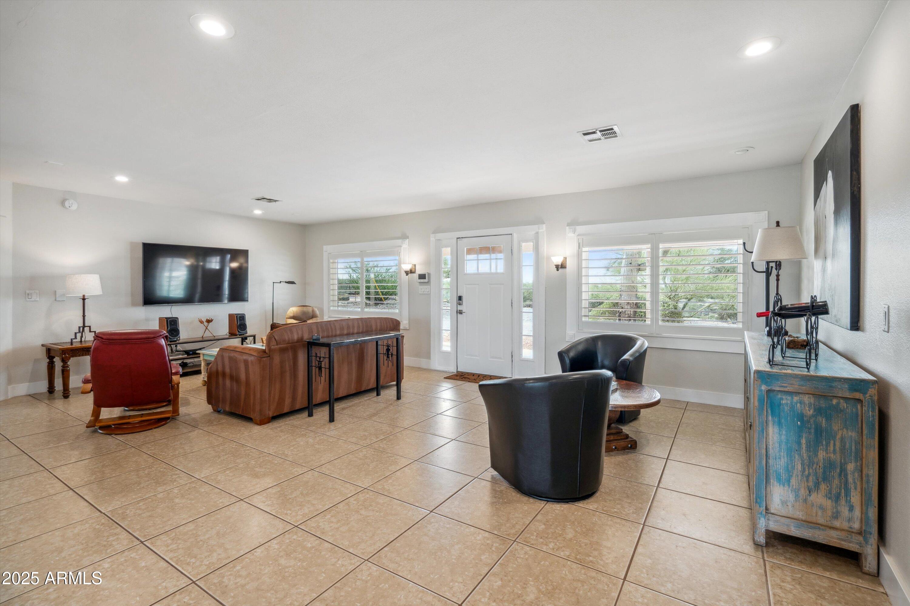 7080 East Arroyo Road Cave Creek, AZ 85331 - Photo 11 of 50 a living room with furniture and a flat screen tv