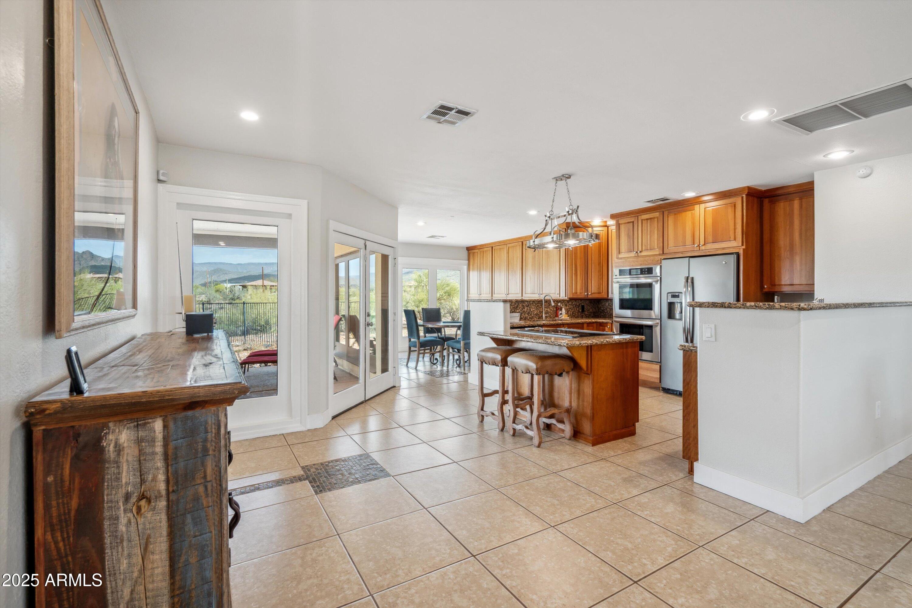 7080 East Arroyo Road Cave Creek, AZ 85331 - Photo 12 of 50 a kitchen with counter top space cabinets and refrigerator
