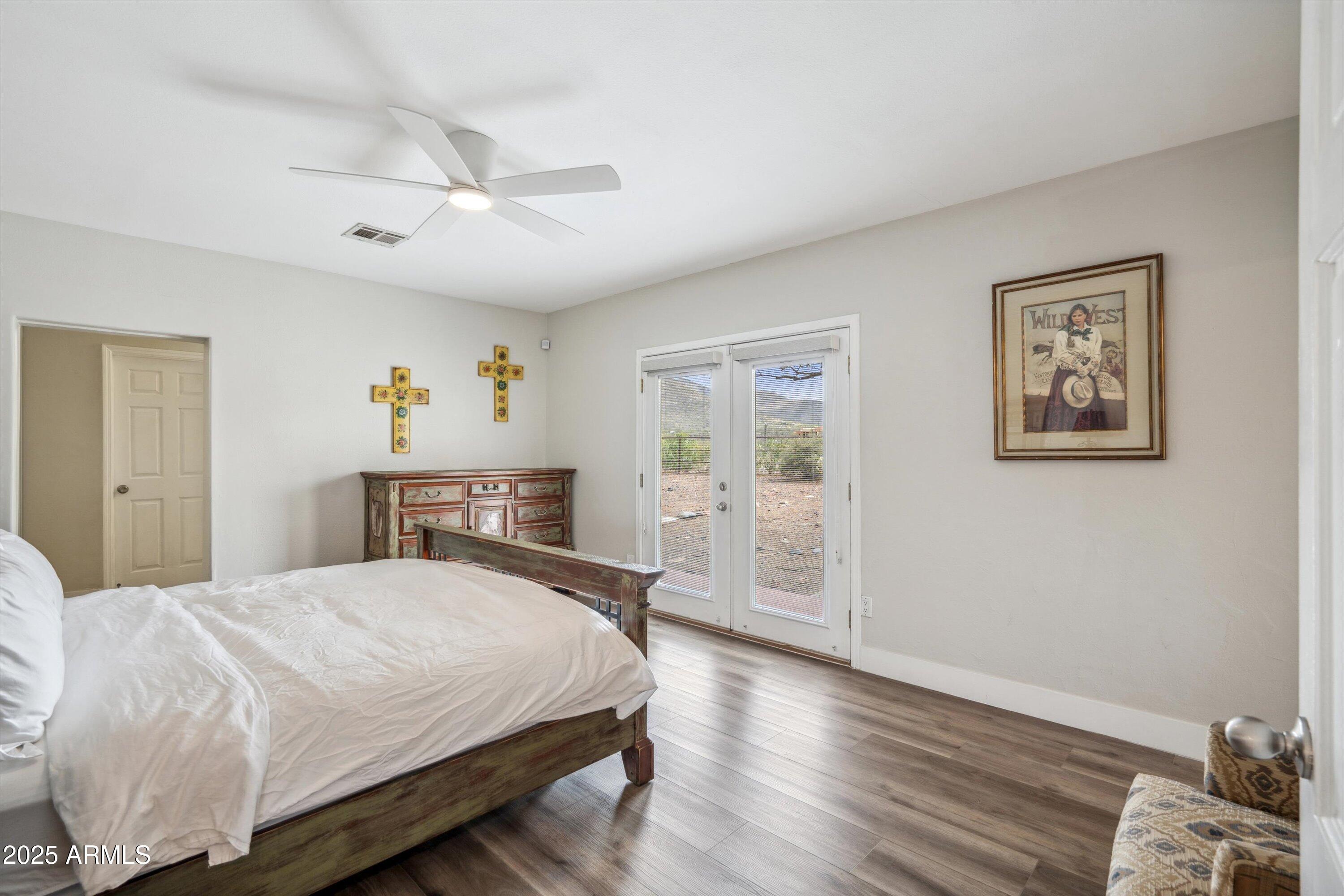 7080 East Arroyo Road Cave Creek, AZ 85331 - Photo 19 of 50 a bedroom with a bed and wooden floor