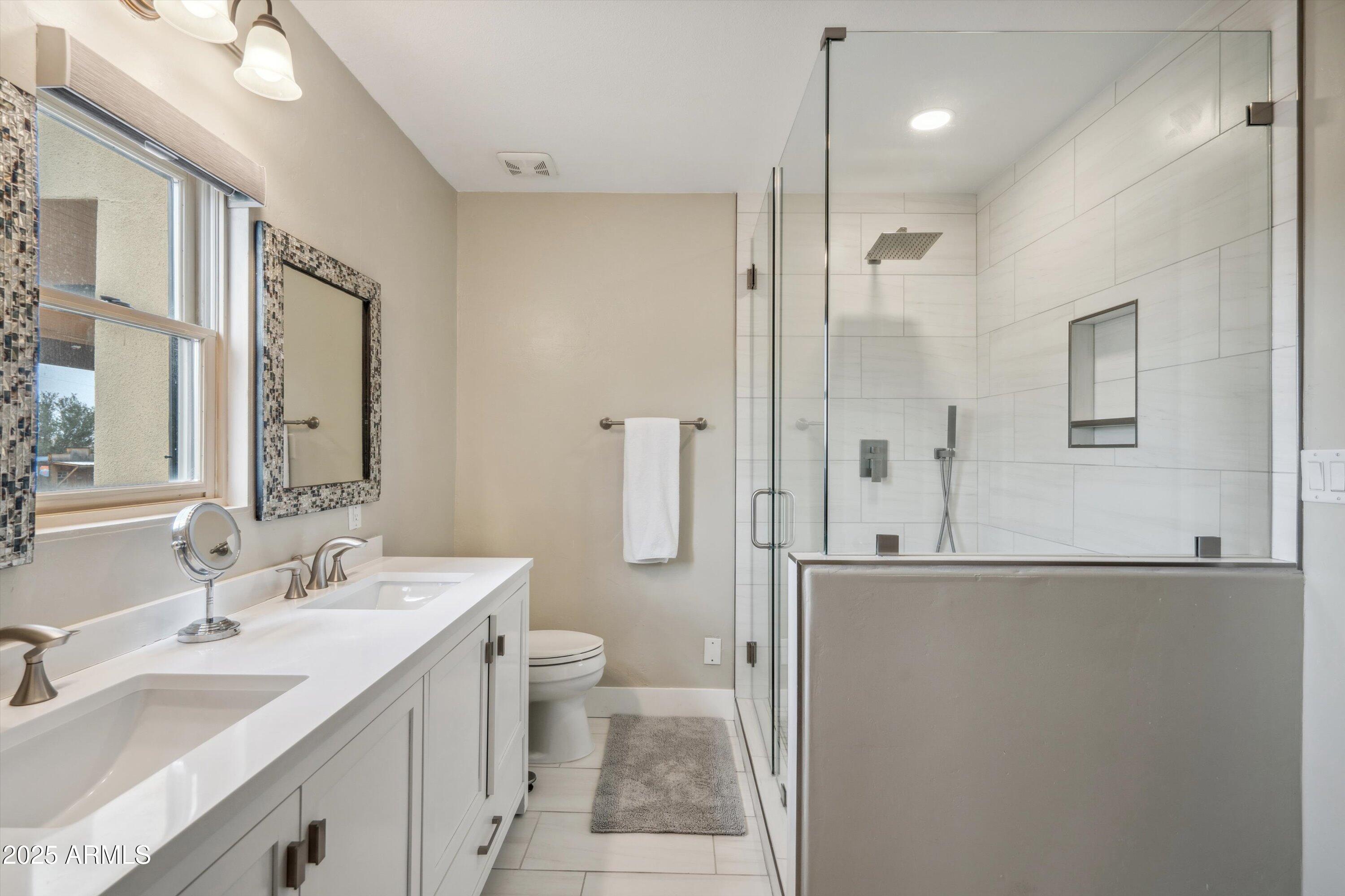 7080 East Arroyo Road Cave Creek, AZ 85331 - Photo 22 of 50 a bathroom with a double vanity sink toilet mirror and shower