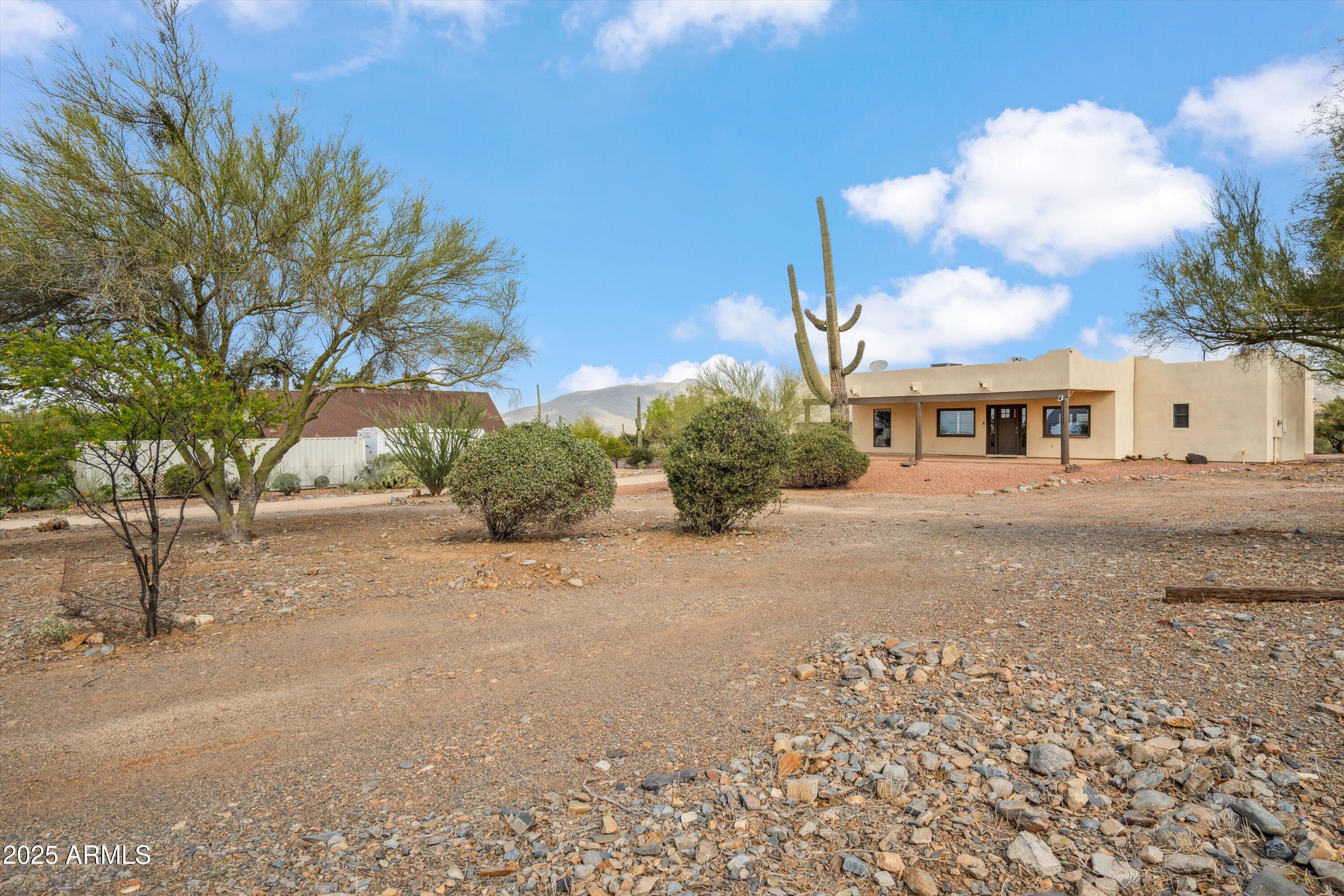 7080 East Arroyo Road Cave Creek, AZ 85331 - Photo 5 of 50 a front view of a house with a yard and garage