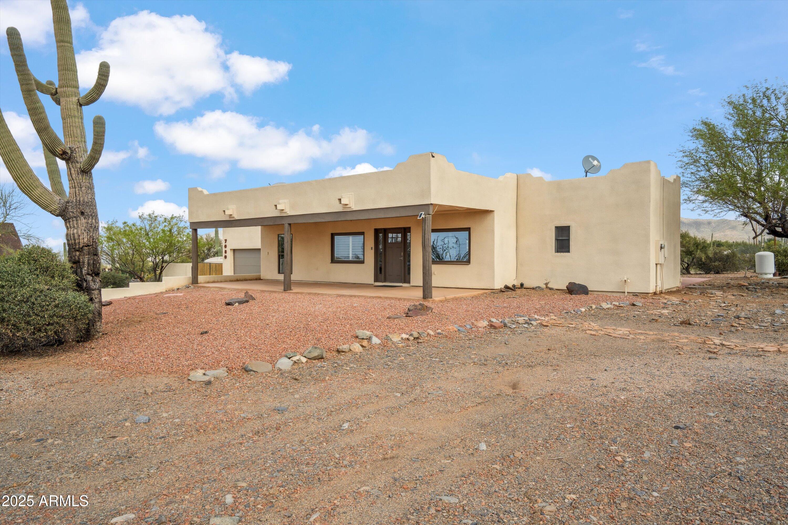 7080 East Arroyo Road Cave Creek, AZ 85331 - Photo 6 of 50 a front view of a house with a dirt road