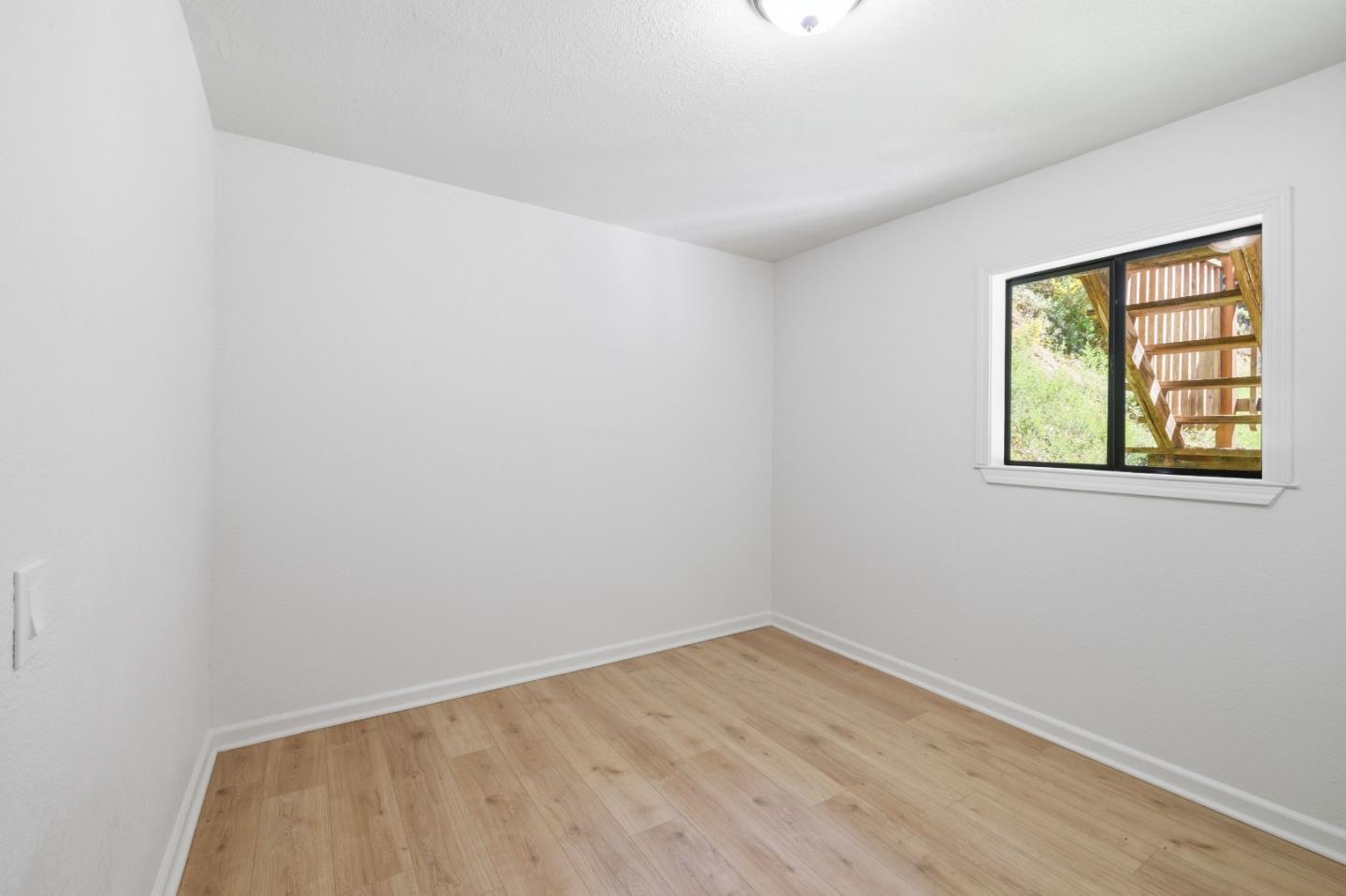 2950 Bear Canyon Road Los Gatos, CA 95033 - Photo 15 of 100 a view of an empty room with wooden floor and a window