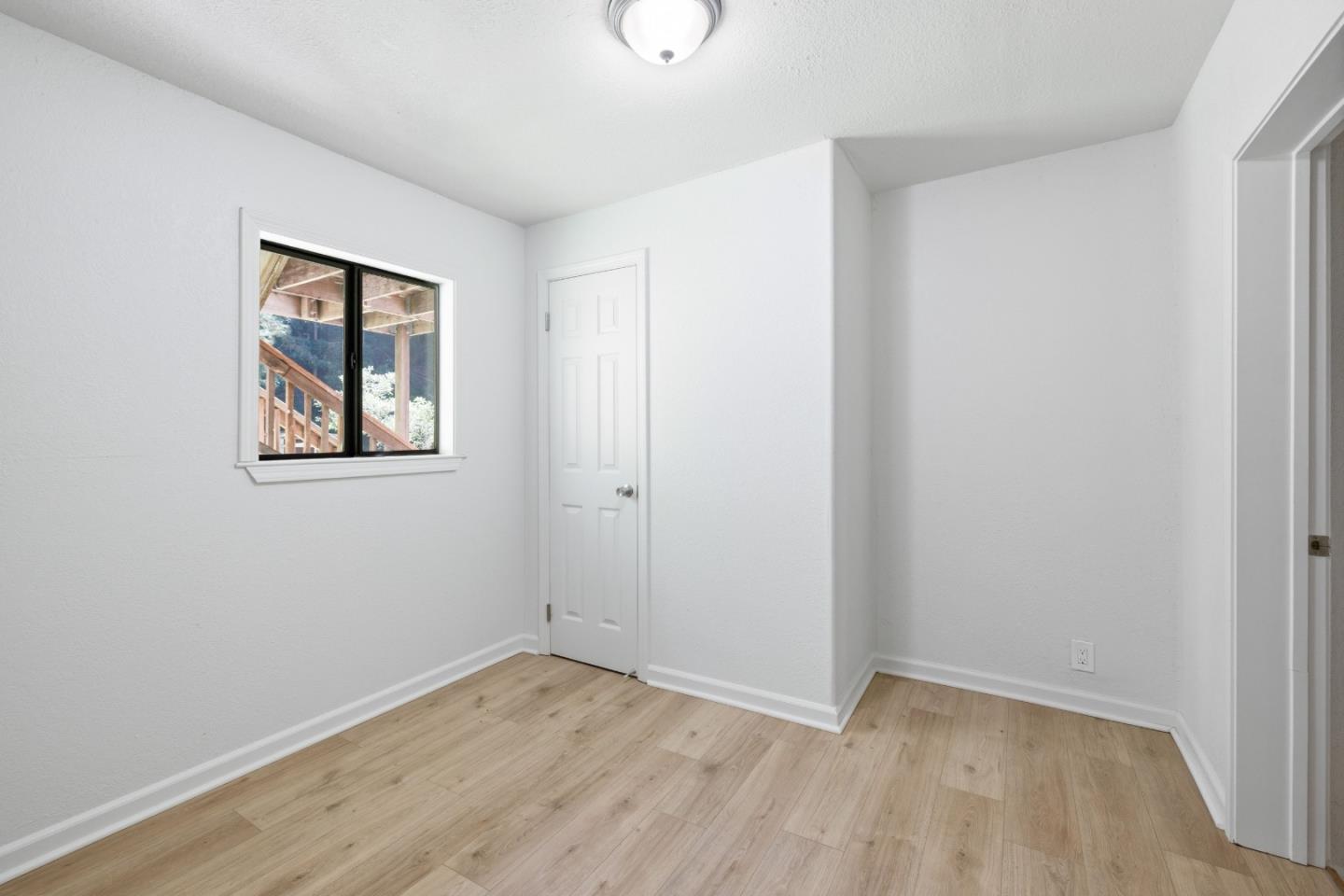 2950 Bear Canyon Road Los Gatos, CA 95033 - Photo 16 of 100 an empty room with a window and wooden floor