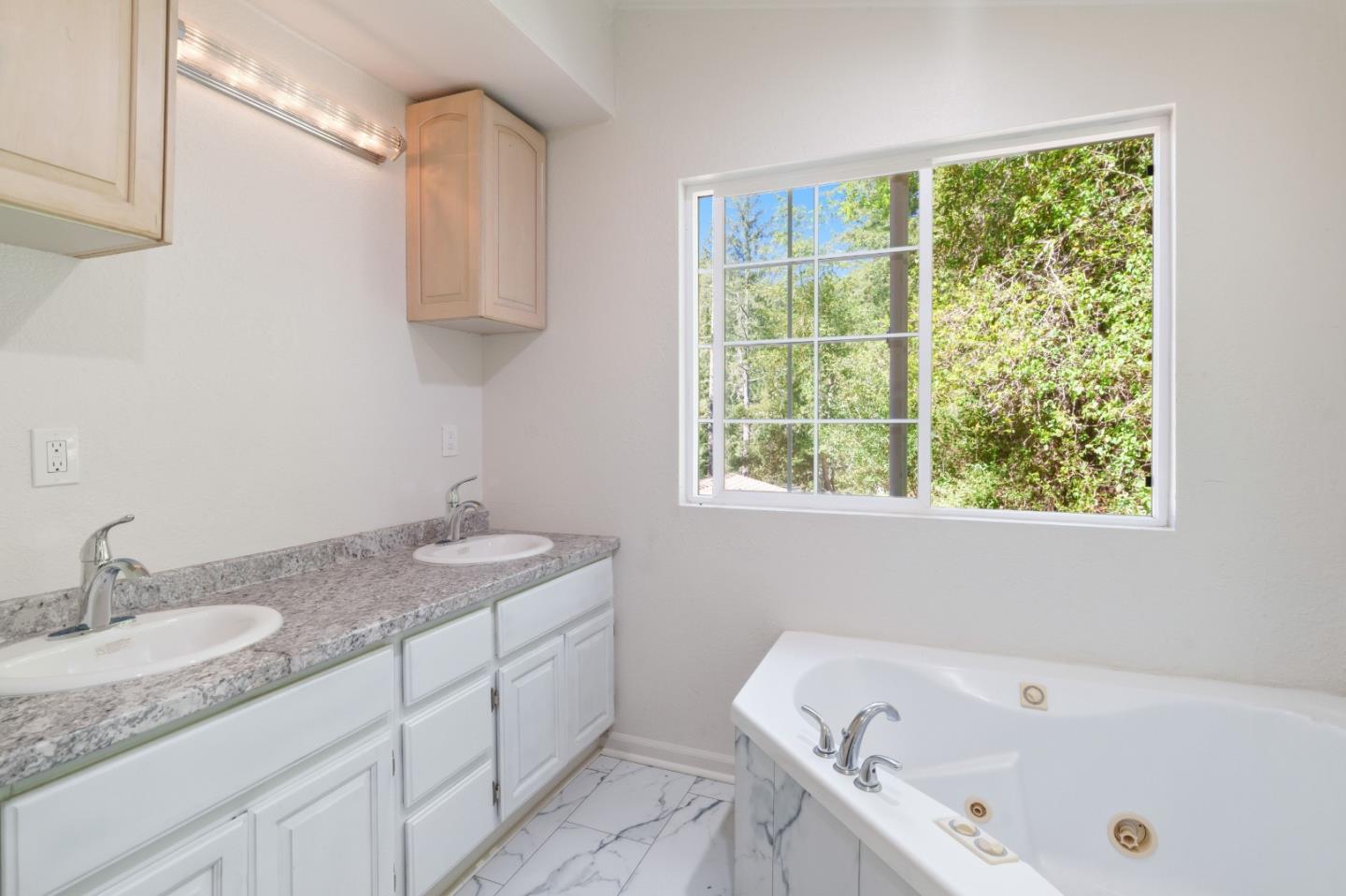 2950 Bear Canyon Road Los Gatos, CA 95033 - Photo 25 of 100 a bathroom with a granite countertop sink and a bathtub