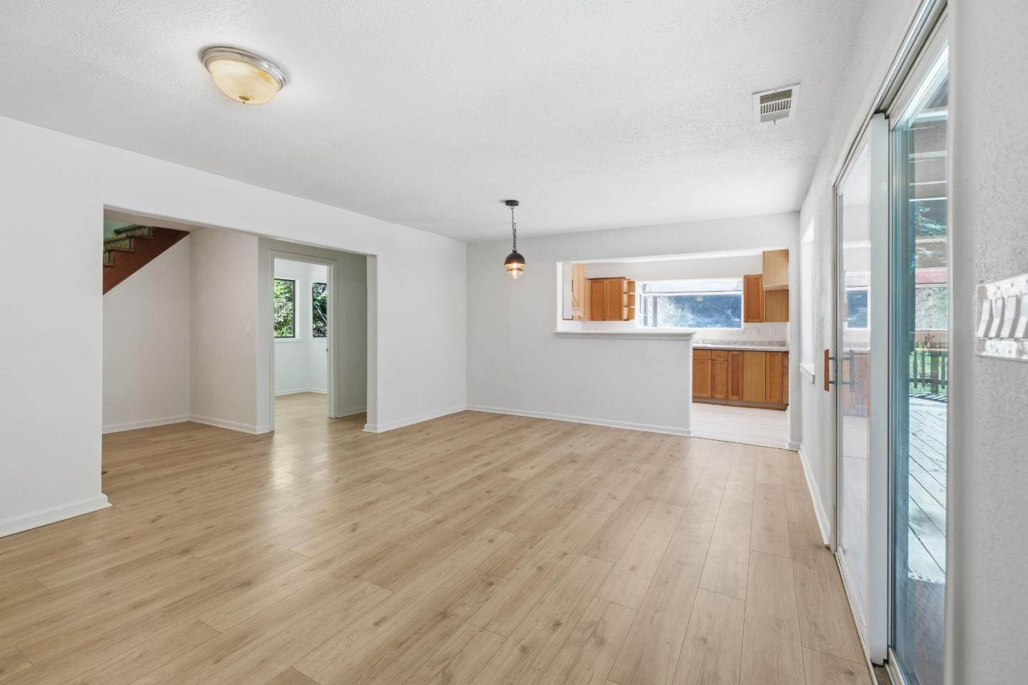 2950 Bear Canyon Road Los Gatos, CA 95033 - Photo 3 of 100 a view of an empty room with wooden floor and a window