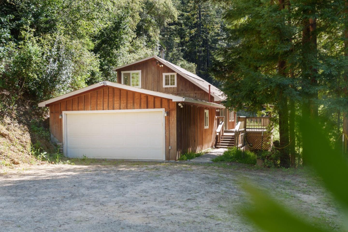 2950 Bear Canyon Road Los Gatos, CA 95033 - Photo 42 of 100 a front view of a house with a yard and garage