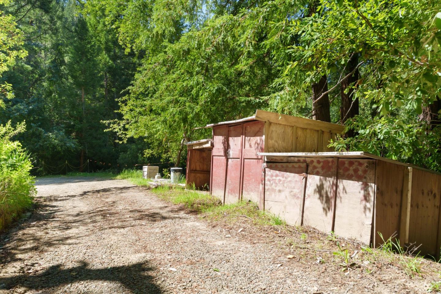 2950 Bear Canyon Road Los Gatos, CA 95033 - Photo 67 of 100 a backyard of a house with large trees and wooden fence