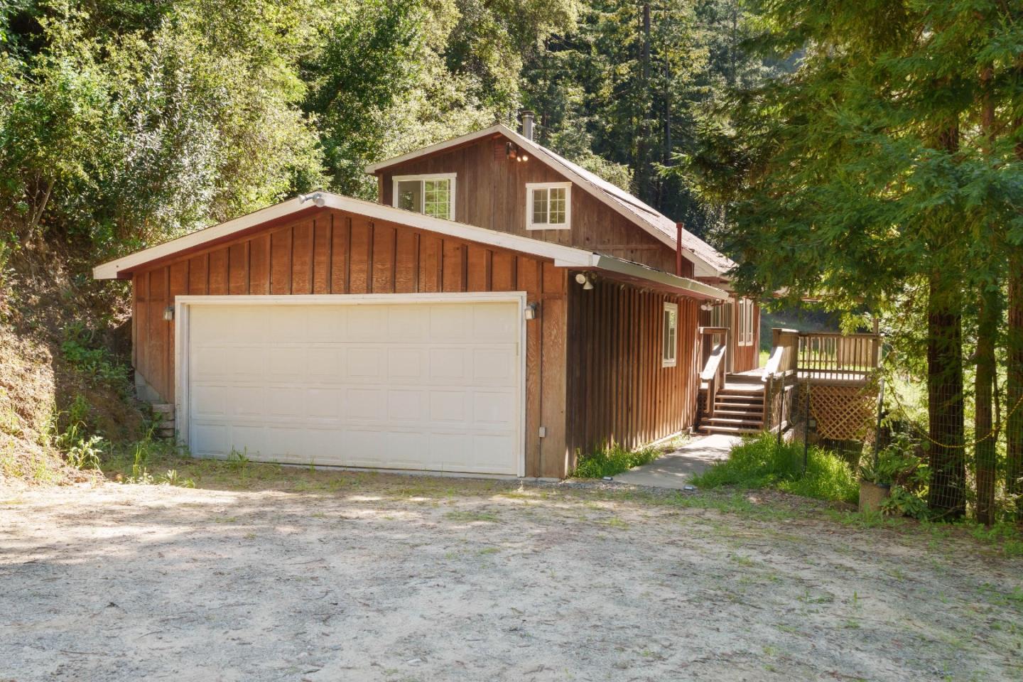 2950 Bear Canyon Road Los Gatos, CA 95033 - Photo 70 of 100 a front view of a house with a yard and garage