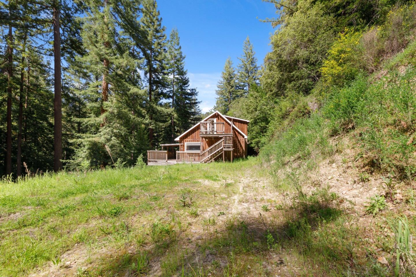2950 Bear Canyon Road Los Gatos, CA 95033 - Photo 85 of 100 a yellow house with trees in the background