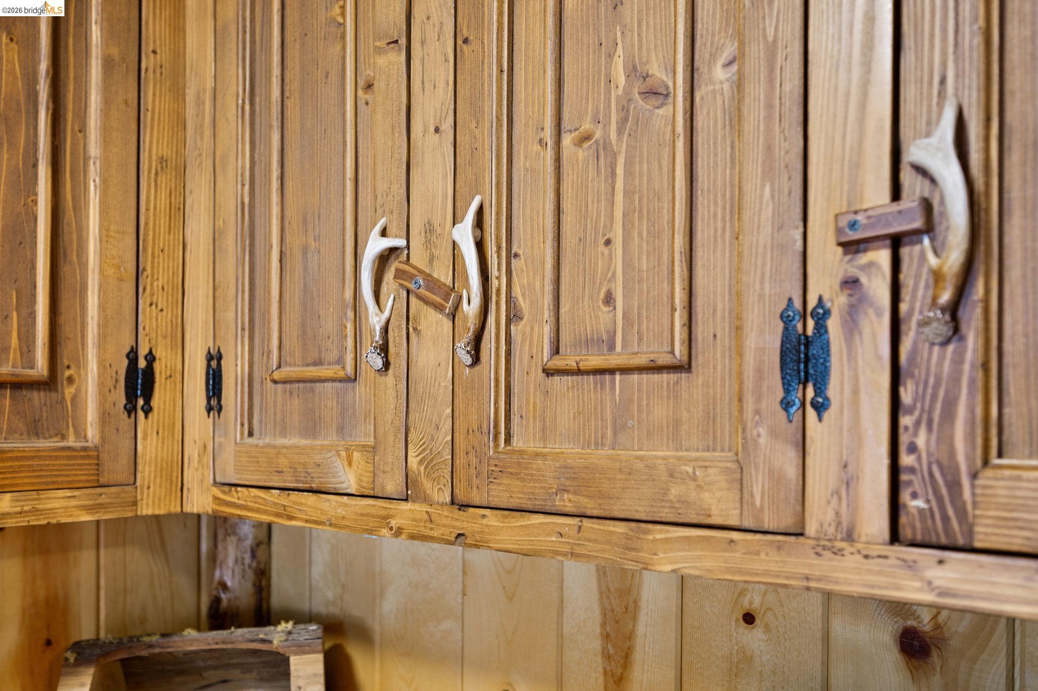 25972 Long Barn Road Long Barn, CA 95335 - Photo 11 of 36 Custom pine cabinetry with unique antler-style hardware, and wrought iron hinges.