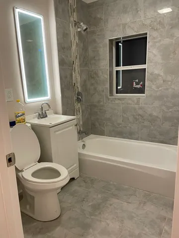 a bathroom with a toilet a sink and bathtub