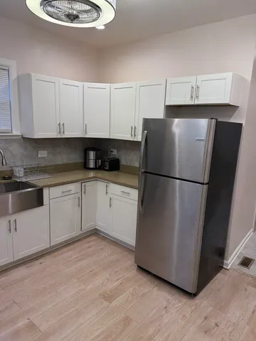 a kitchen with stainless steel appliances granite countertop a refrigerator sink and cabinets