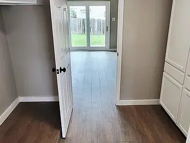 an empty room with wooden floor and a window