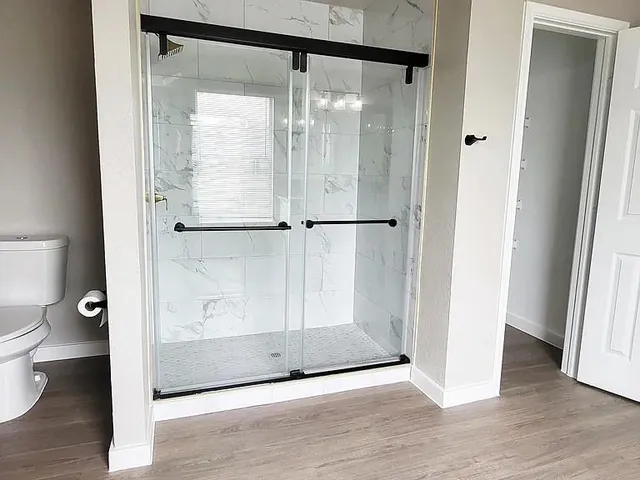 a bathroom with a glass shower door