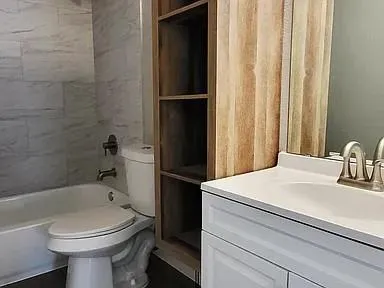 a bathroom with a sink toilet and shower