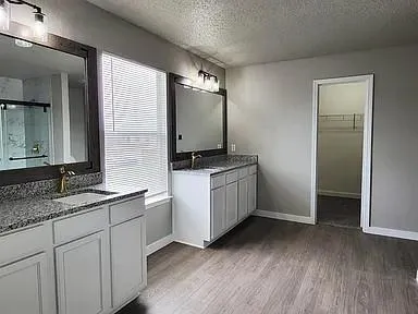 a kitchen with sink cabinets and wooden floor