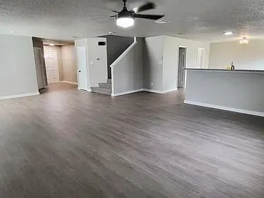 a view of a kitchen with a sink and a refrigerator
