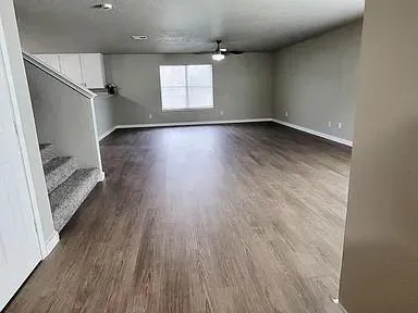 wooden floor in an empty room with a window
