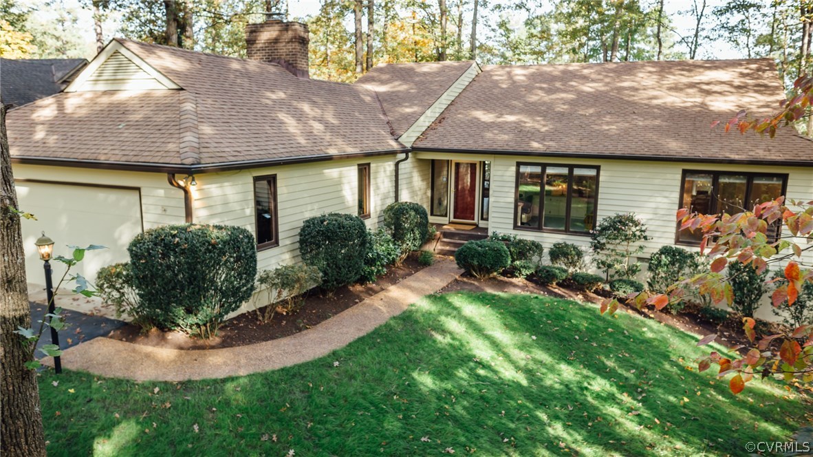 a front view of house with yard and outdoor seating