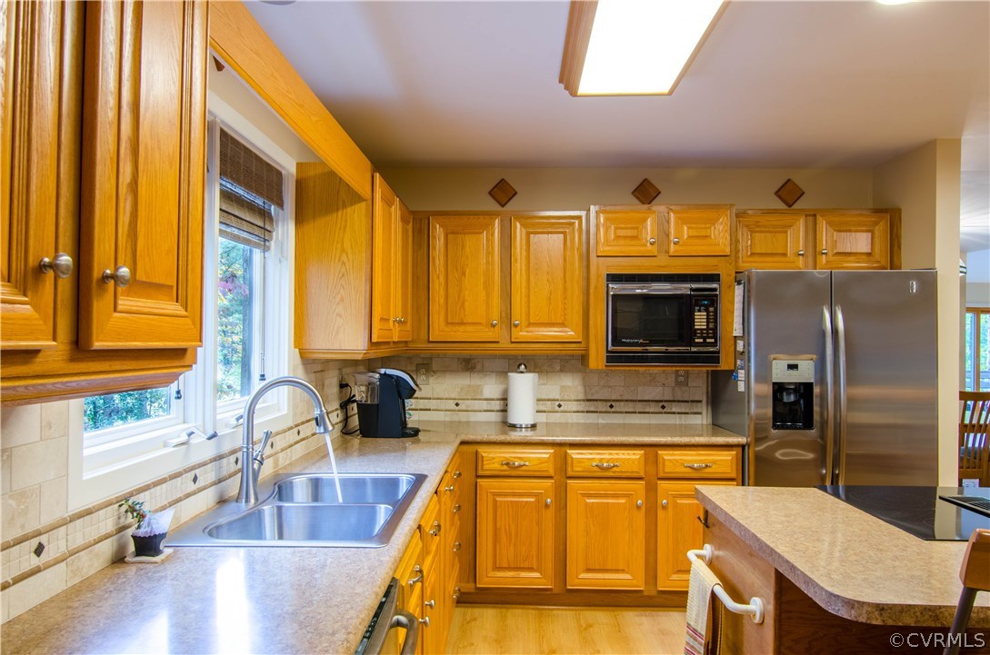 13810 Sterlings Bridge Road Midlothian, VA 23112 - Photo 10 of 38 a kitchen with stainless steel appliances wooden floor and a refrigerator