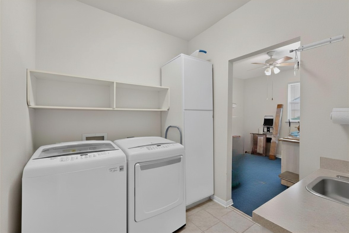 207 Red Poppy Trail Georgetown, TX 78633 - Photo 24 of 31 Laundry inside with sink and additional storage. Storage or hobby room located off of laundry room before entering garage.