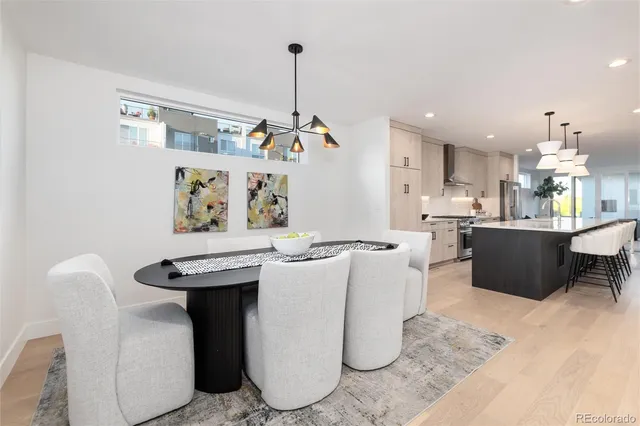 a kitchen with stainless steel appliances a sink a stove a refrigerator and cabinets