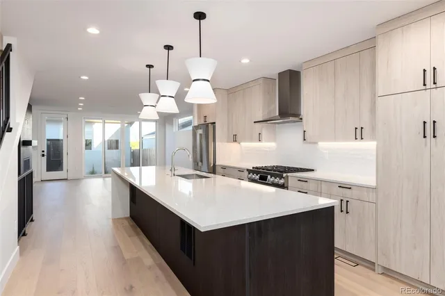 a view of an empty room with a cabinet and mirrors