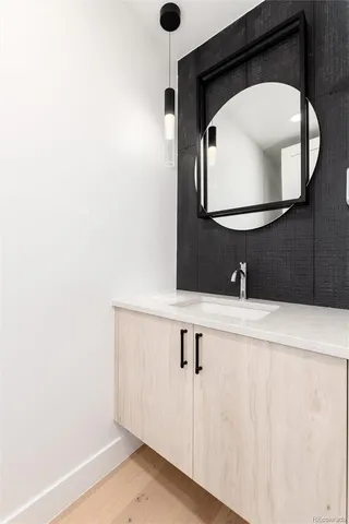 a bedroom with a bed mirror and window