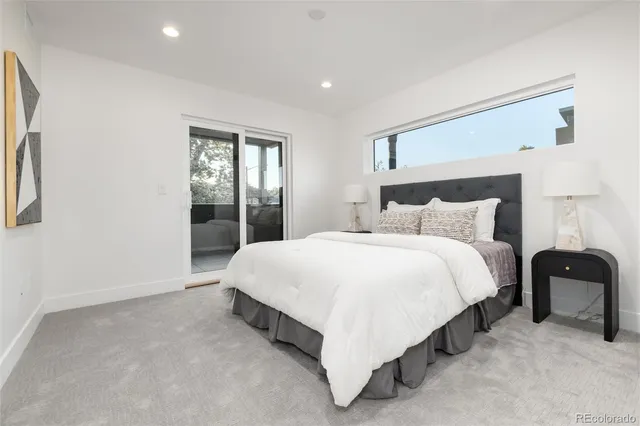 a bathroom with a toilet sink vanity tub and shower