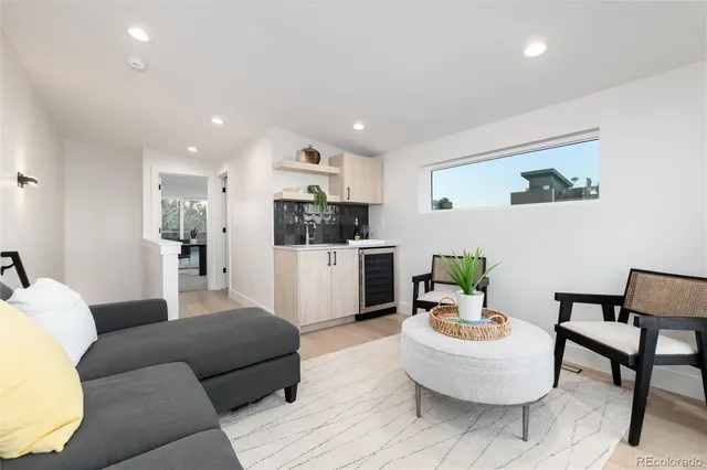a view of a kitchen with refrigerator and white cabinets