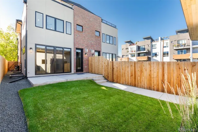 a building outdoor space with patio furniture and potted plants