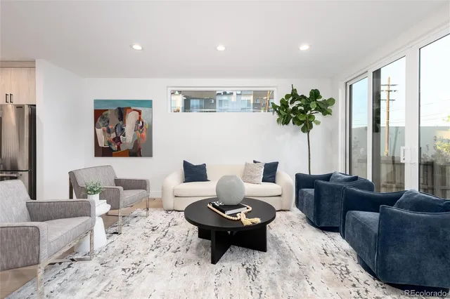 a living room with furniture or couch and a potted plant