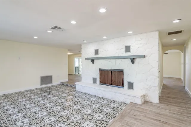 a view of a kitchen and a fireplace