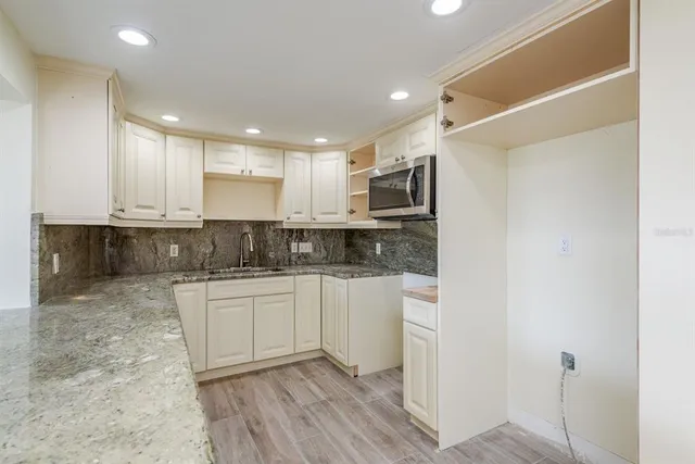 a kitchen with a sink and cabinets