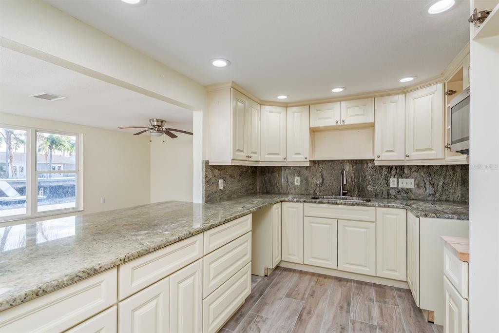13816 Celida Avenue Hudson, FL 34667 - Photo 17 of 42 a kitchen with a sink and cabinets