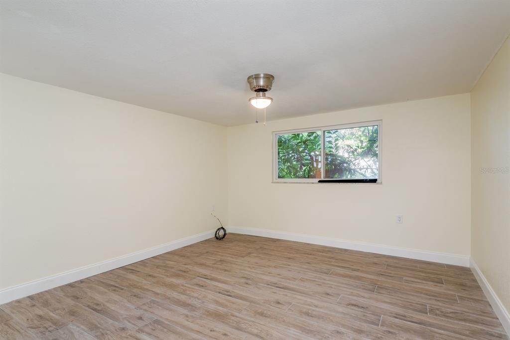 13816 Celida Avenue Hudson, FL 34667 - Photo 19 of 42 an empty room with wooden floor and windows
