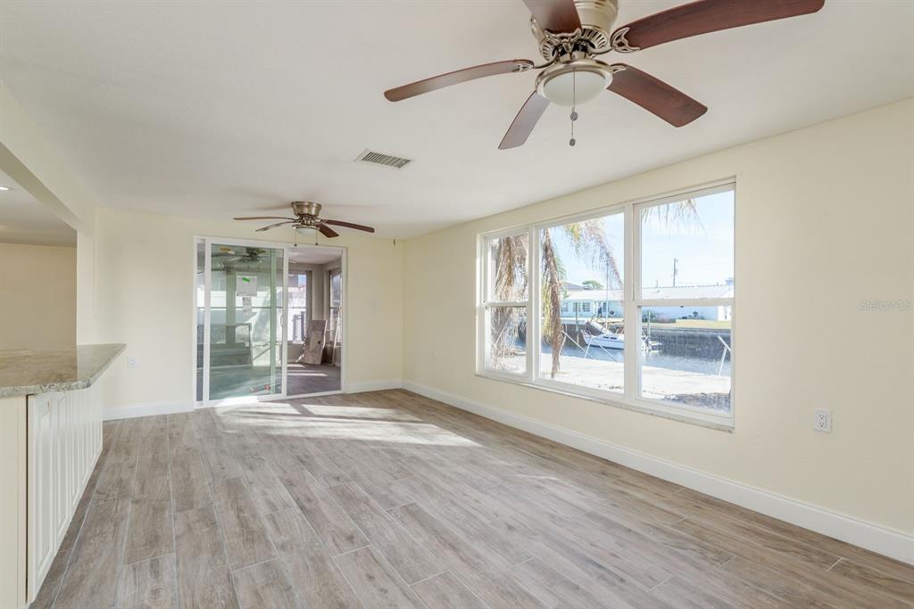 13816 Celida Avenue Hudson, FL 34667 - Photo 24 of 42 a view of an empty room with a window and wooden floor