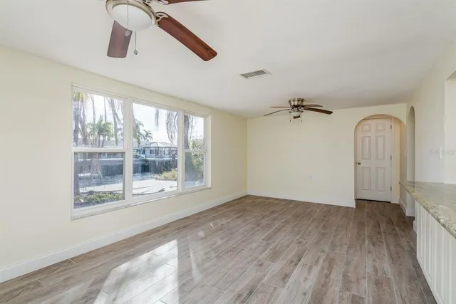 a view of a hallway with closet and a chandelier fan