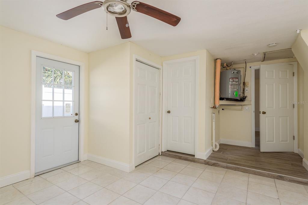 13816 Celida Avenue Hudson, FL 34667 - Photo 27 of 42 a view of a hallway with closet and a chandelier fan