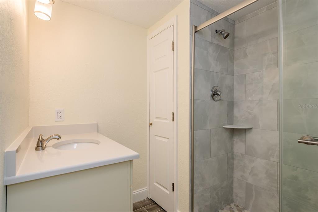 13816 Celida Avenue Hudson, FL 34667 - Photo 29 of 42 a bathroom with a sink and shower