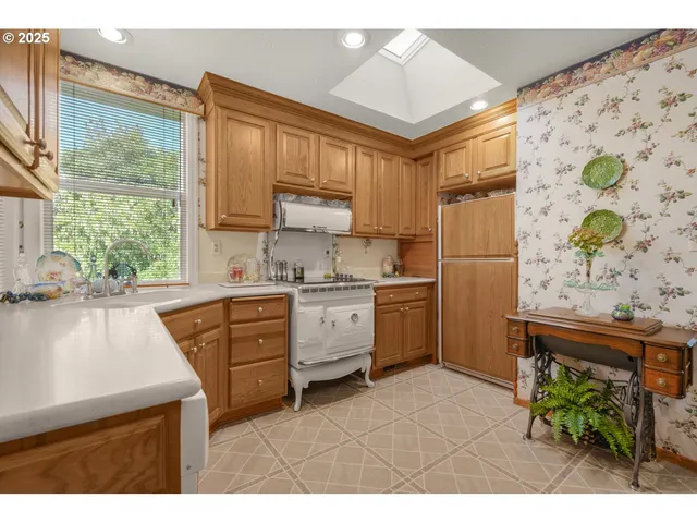 a kitchen with a stove a sink and a refrigerator