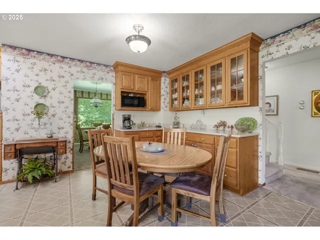 a view of a dining room with furniture and a flat screen tv