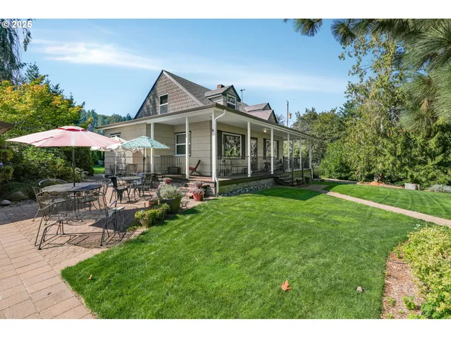 a view of a house with a yard and sitting area