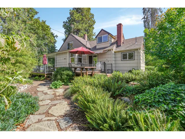 a front view of a house with a yard and trees