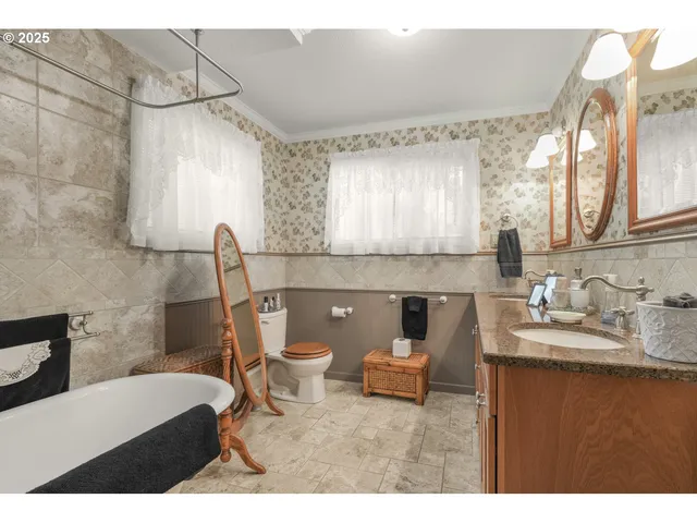 a bathroom with a sink toilet and mirror