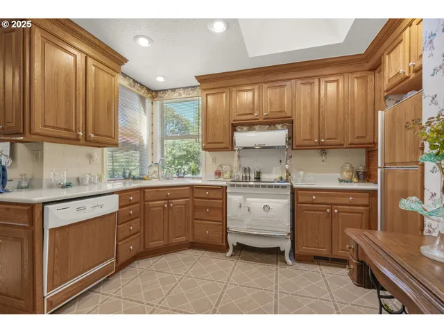 a kitchen with granite countertop a sink stainless steel appliances and cabinets