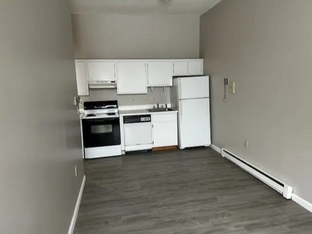a kitchen with wooden cabinets and a stove top oven