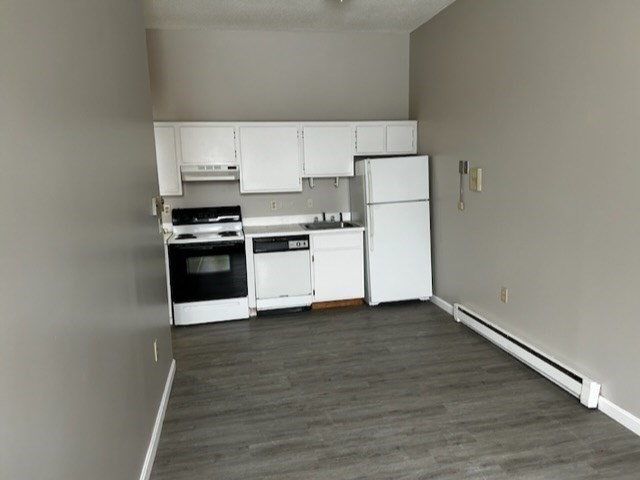 a kitchen with wooden cabinets and a stove top oven