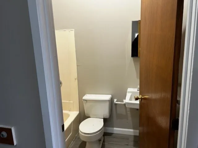 a white toilet sitting next to a small bathroom